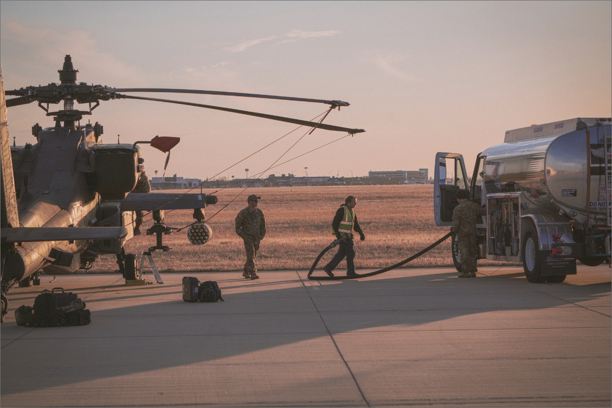 Workers refueling a helicopter